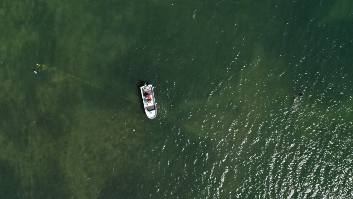 Aerial photo of a small boat in a large body of water