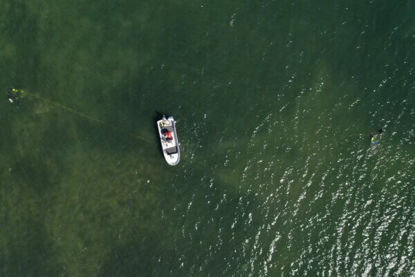 Aerial photo of a small boat in a large body of water
